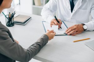 a doctor and patient discuss drug rehab insurance coverage