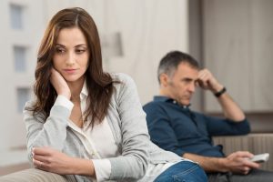 man and woman sit in frustration over a relationship with an alcoholic