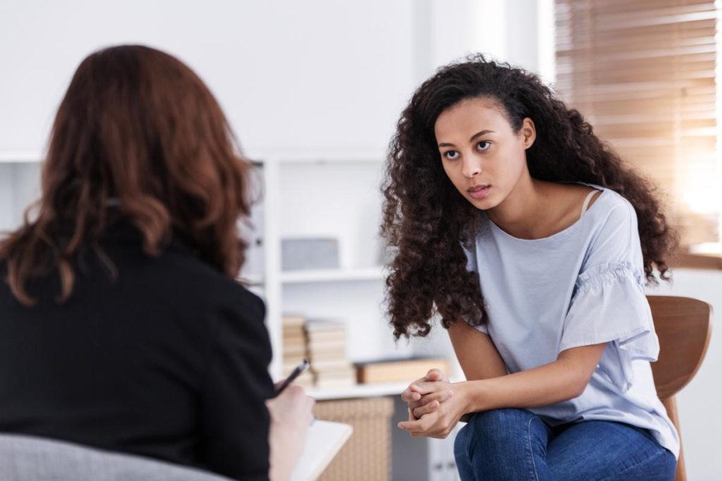 an adult woman talks with her therapist about substance abuse and borderline personality disorder