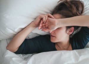 a woman lays in bed not wanting to get up and is showing the physical effects of benzos