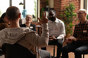 man in group therapy session talks about addiction therapy programs 