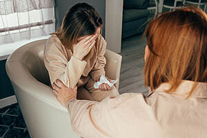 woman comforts friend who is seeking depression treatment in texas