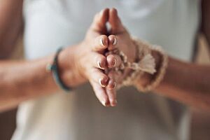 person puts hands together in a holistic detox program in texas