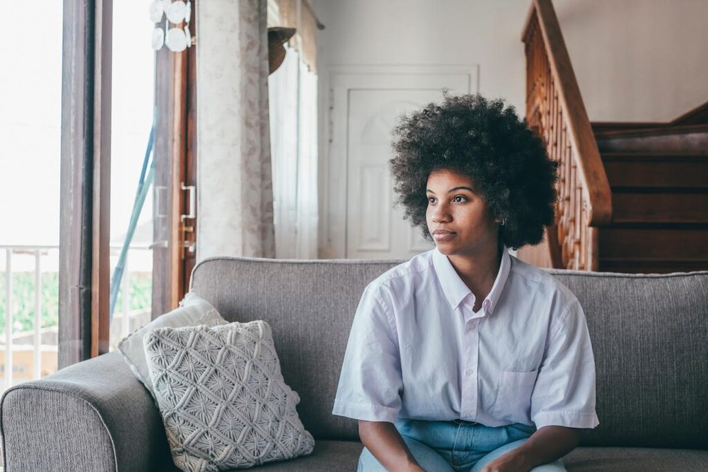 woman looking out of a window thinking about the benefits of inpatient rehab