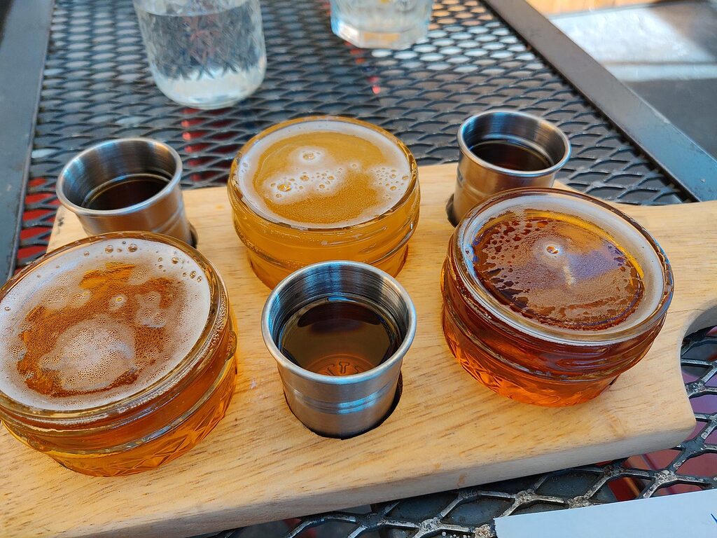 Beer and whisky being served on a flight